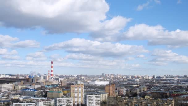 Pipes of thermal power plant stand against city and sky — Stock Video