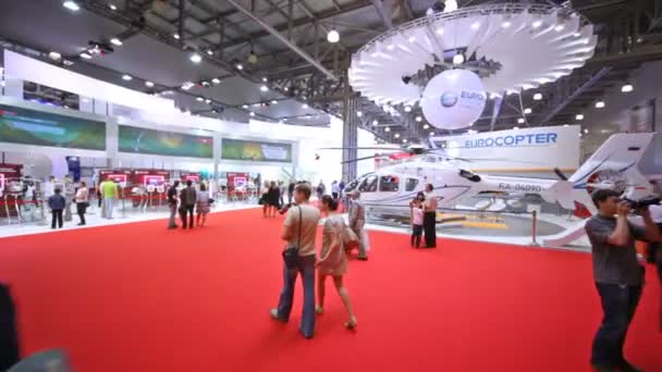 People consider models of helicopters on exhibition — Stock Video