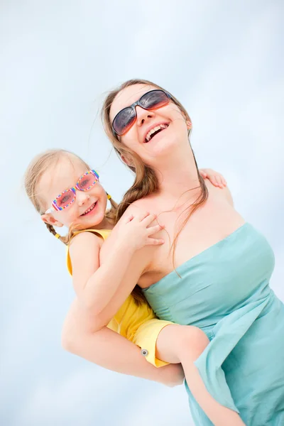 Mother and daughter having fun outdoors Stock Photo