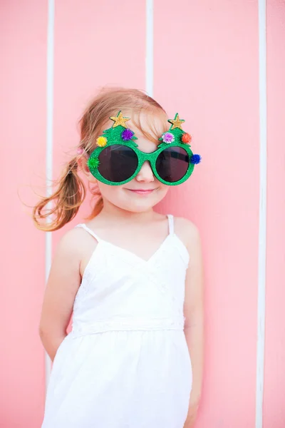 Little girl wearing funny Christmas glasses — Stock Photo, Image