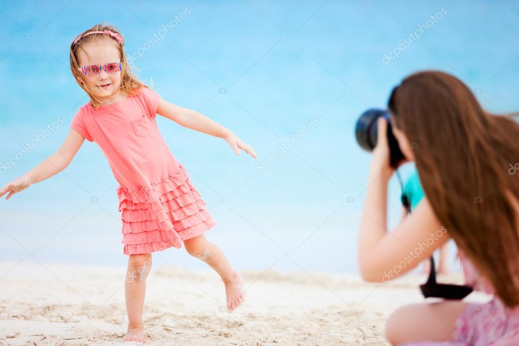 Mother photographing her daughter