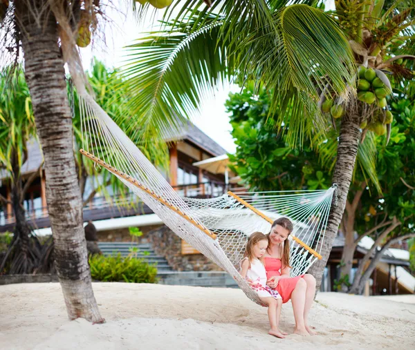 Mother and daughter relaxing in hammock Stock Image