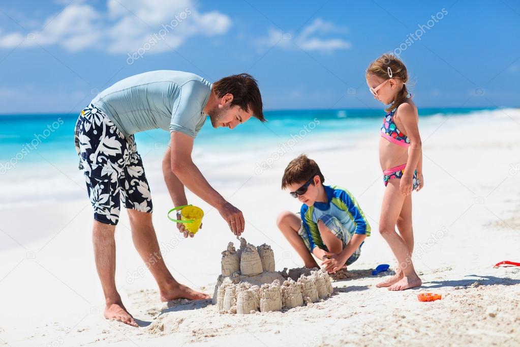 Father and kids playing at beach
