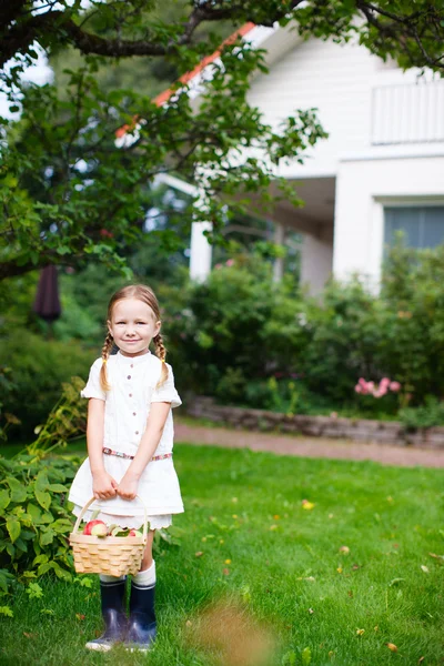 Little girl with apples — Stock Photo, Image