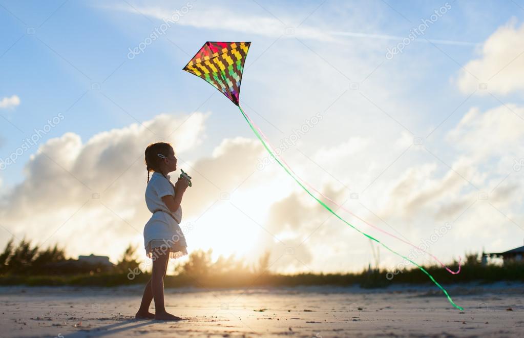 Little girl flying a kite