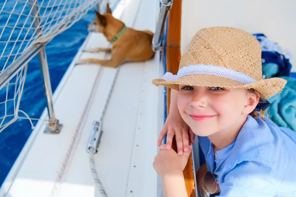 Little girl at luxury yacht with pet dog — Stock Photo, Image