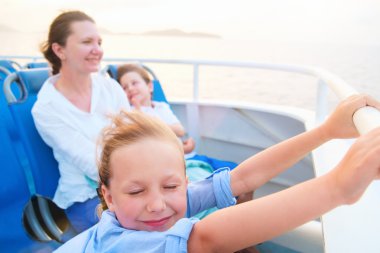 Family enjoying ride on ferry clipart