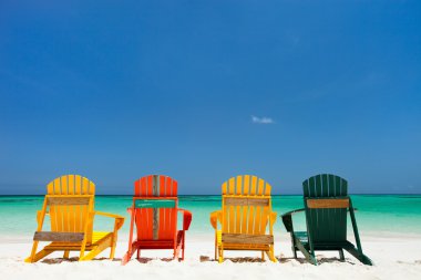 Colorful chairs on Caribbean beach clipart