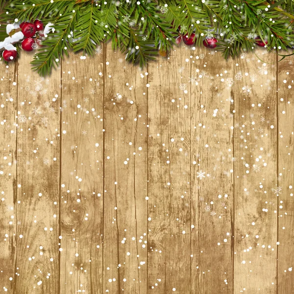 Kerstmis fir twig met rode bessen op de houten achtergrond — Stockfoto