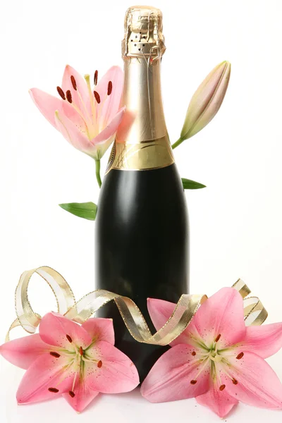 Champagne and pink lilies — Stock Photo, Image