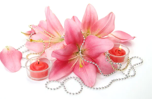 Pink lilies and candles — Stock Photo, Image