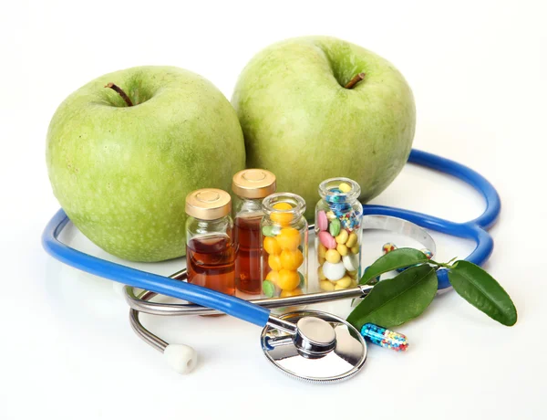 Tablets for treatment of illness and apples — Stock Photo, Image