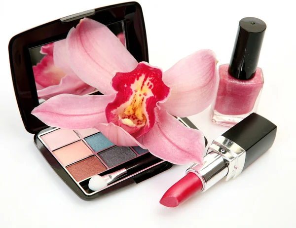 Dekoratív kozmetikumok és rózsaszín orchidea — Stock Fotó