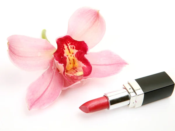 Decorative cosmetics and pink orchid — Stock Photo, Image