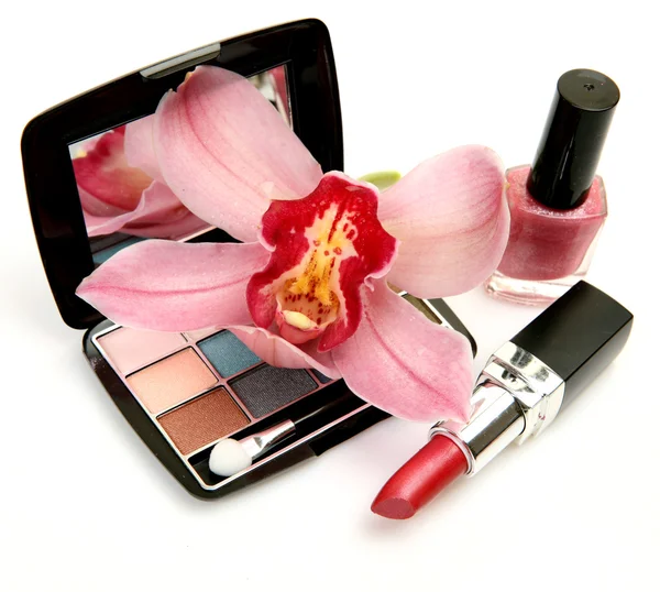 Decorative cosmetics and orchid — Stock Photo, Image