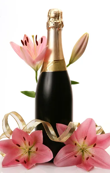 Champagne and pink lilies — Stock Photo, Image