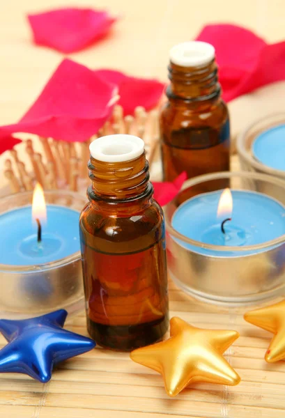 Bottle and oil and candles — Stock Photo, Image