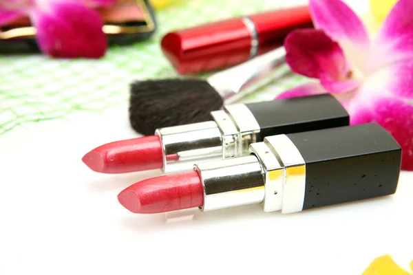 Pink orchid and lipstick — Stock Photo, Image