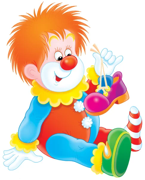 Clown holding up one of his shoes and sitting on the floor — Stock Photo, Image