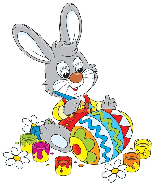 Bunny paints an Easter egg — Stock Vector