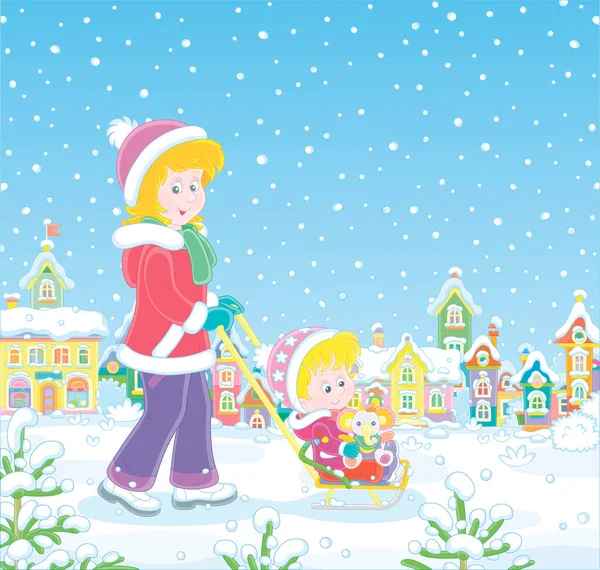 Genç ve sevimli anne, karlı bir kış gününde, küçük bir kasabanın karla kaplı bir caddesinde komik bir oyuncak fille mutlu küçük kızını kızaklıyor.