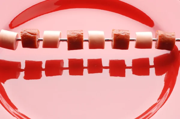 Sausage on red plate — Stock Photo, Image