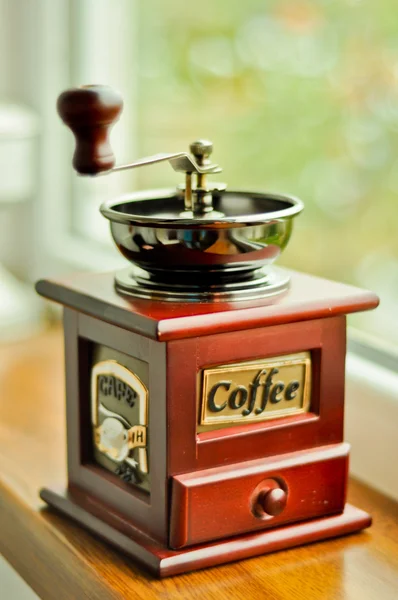 Old-fashioned coffee grinder with coffee beans Stock Photo