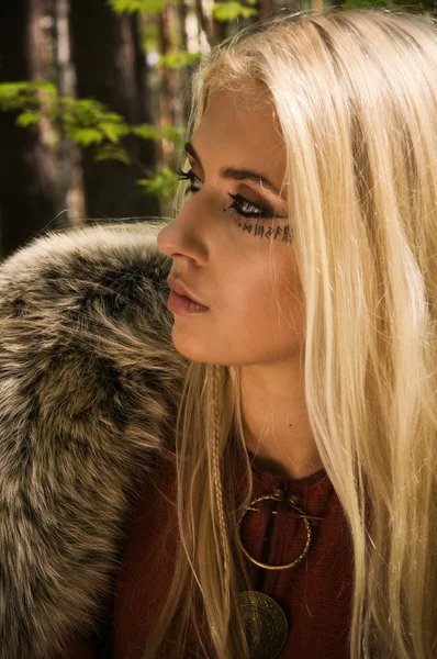 Scandinavian girl with runic signs — Stock Photo, Image