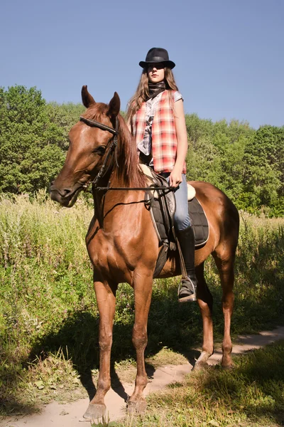 Cowgirl riding a bay horse — Stock Photo, Image