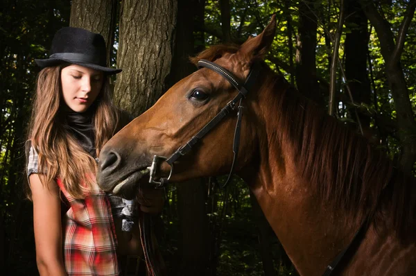 Cowgirl in hat with bay horse — Stock Photo, Image