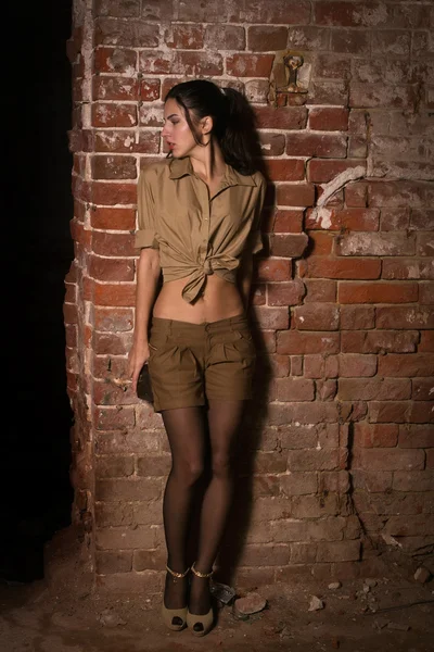 Frightened brunette hiding in the ruins — Stock Photo, Image