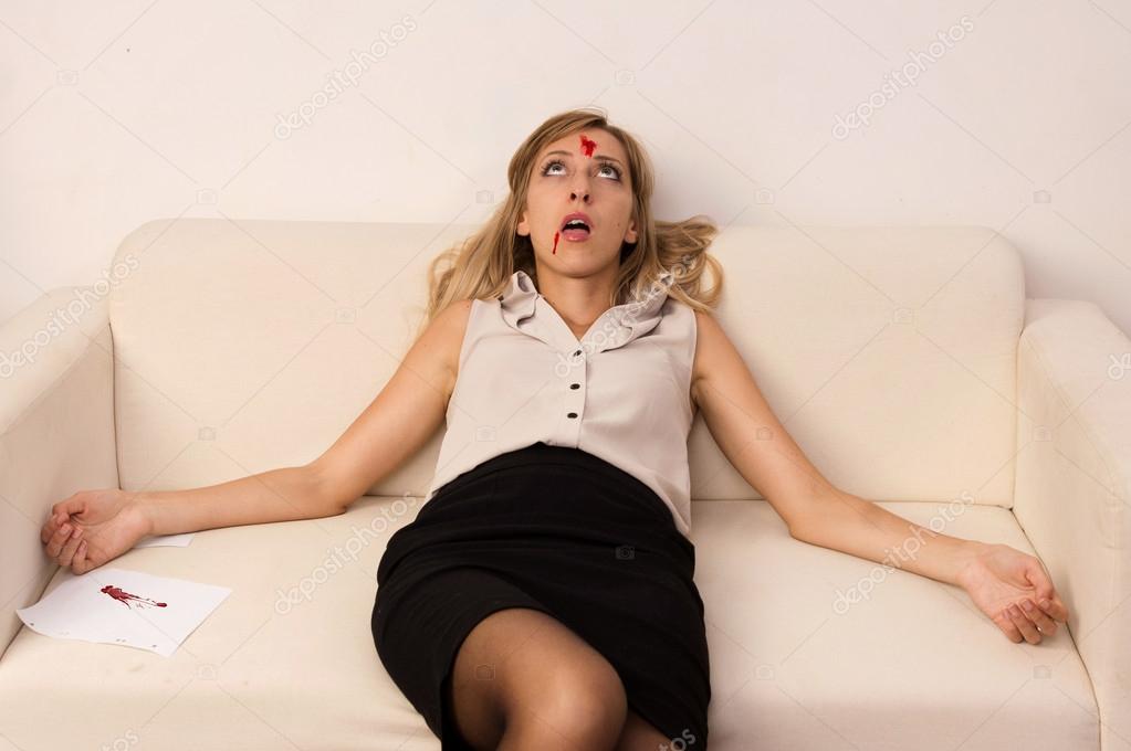Lifeless business woman lying on sofa (imitation)