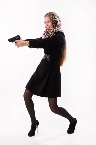 Spy girl shoots a gun — Stock Photo, Image