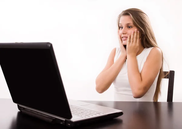 Astonished girl behind a laptop — Stock Photo, Image