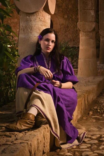 Brunette girl in a medieval suit in a Agia Napa Medieval Monaste — Stock Photo, Image