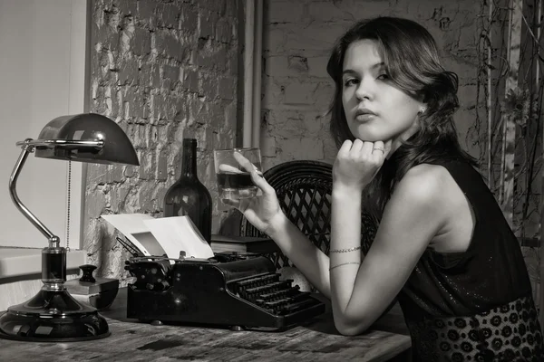 Elegant woman in black with the old typewriter — Stock Photo, Image