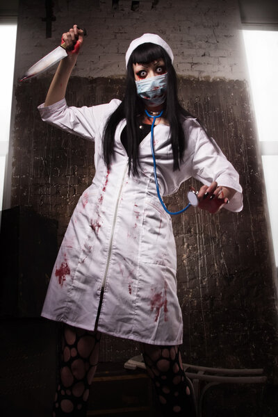 Crazy dead nurse with knife in the hand