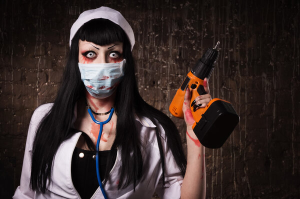 Crazy dead nurse with drill in the hand