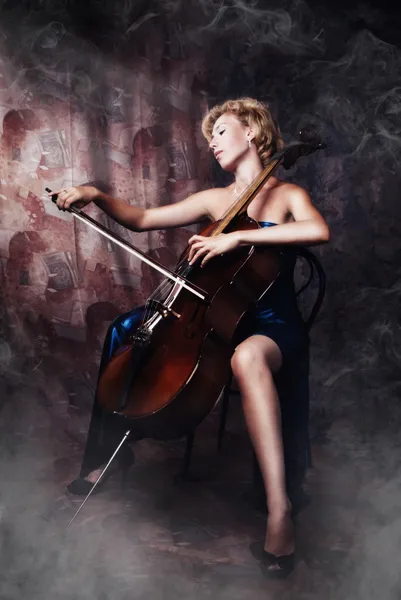 Beauty woman in evening dress playing cello — Stok Foto