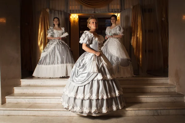 Three young women in ball gowns — Stock Photo, Image