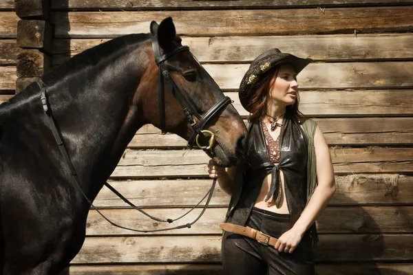 Cowgirl and brown horse — Stock Photo, Image