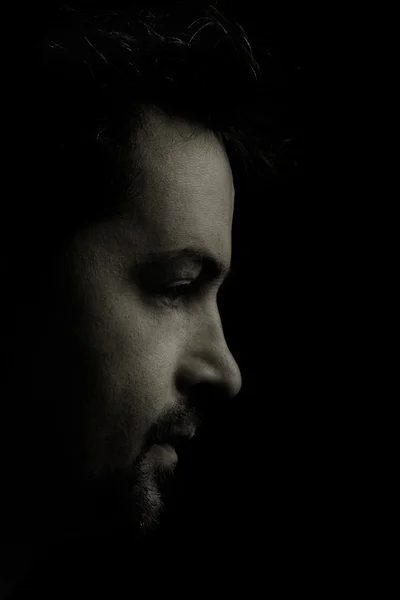 Close-up man's portrait against black background — Stock Photo, Image