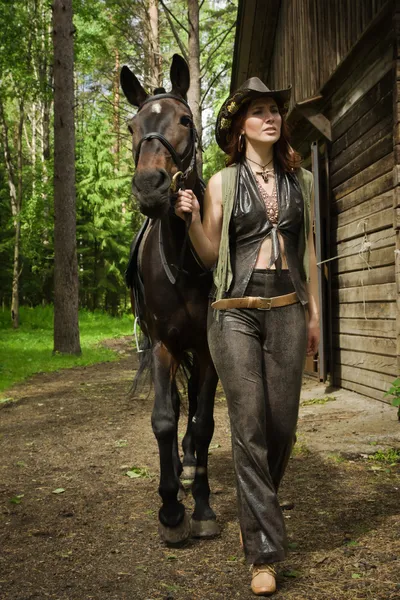 Cowgirl and brown horse — Stock Photo, Image