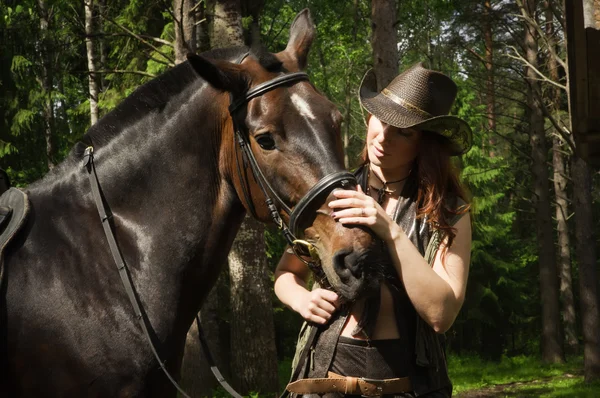 Cowgirl and brown horse — Stock Photo, Image