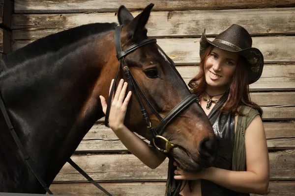 Cowgirl met bruin paard — Stockfoto