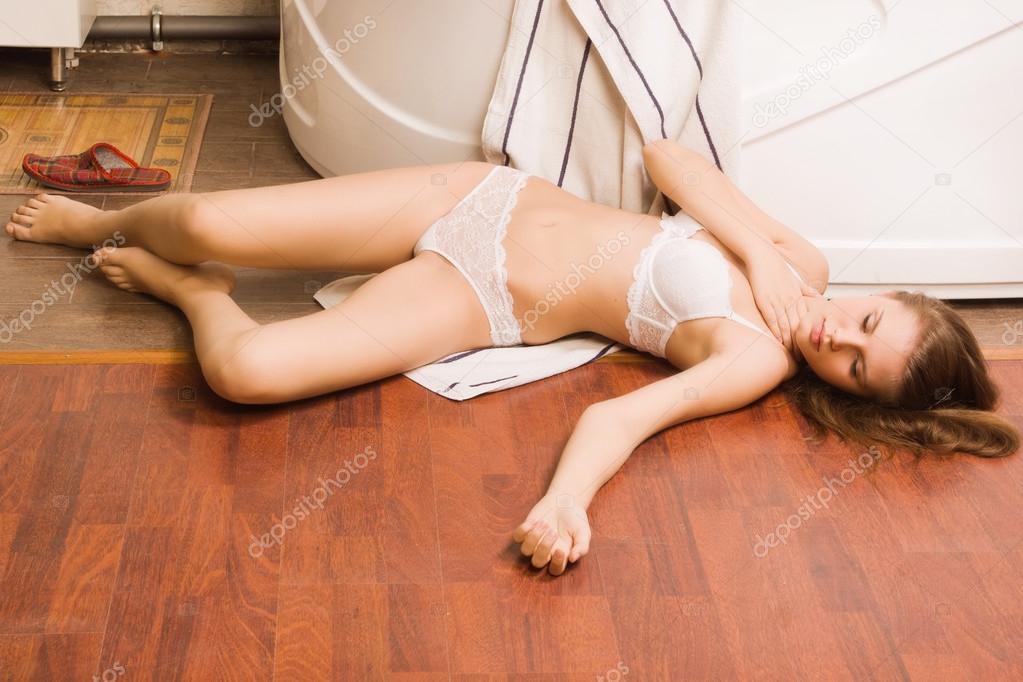 Crime scene simulation. Lifeless girl lying on the floor