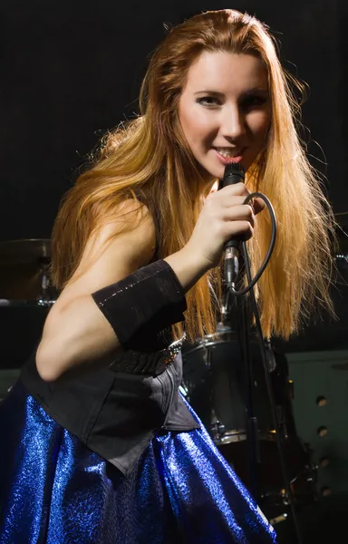 Rock star girl singing in a studio — Stock Photo, Image