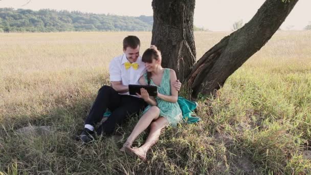 Young couple browsing in Internet with tablet and chating — Stock Video