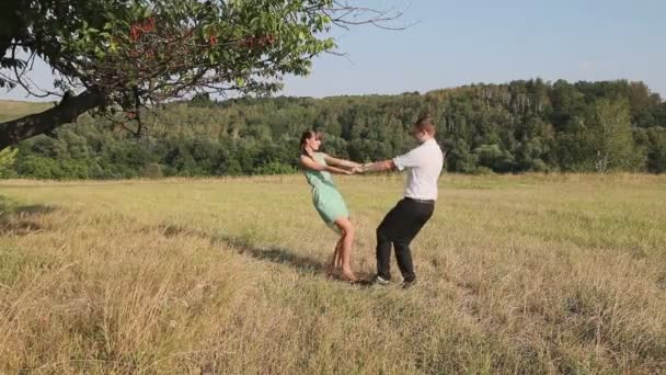 Man and woman dancing in the field — Stock Video