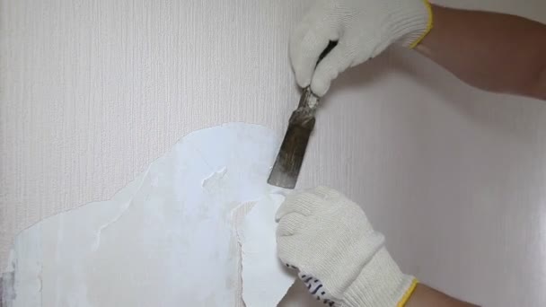 Mężczyzna usuwania starej tapety z narzędziem — Wideo stockowe
